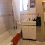 Shower over full sized bath in Monet's Retro two bedroom self contained flat