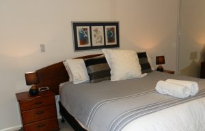 king sized bed in the master bedroom short term rentals in Perth