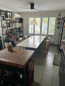 A long terrazzo table for dining or office in the Frangipani Apartment Fremantle