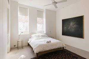 Stylish king sized bedroom in the Architect's Warehouse Apartment 30D Fremantle
